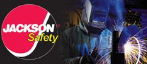 A welder wearing protective gear works on a metal piece, with the 